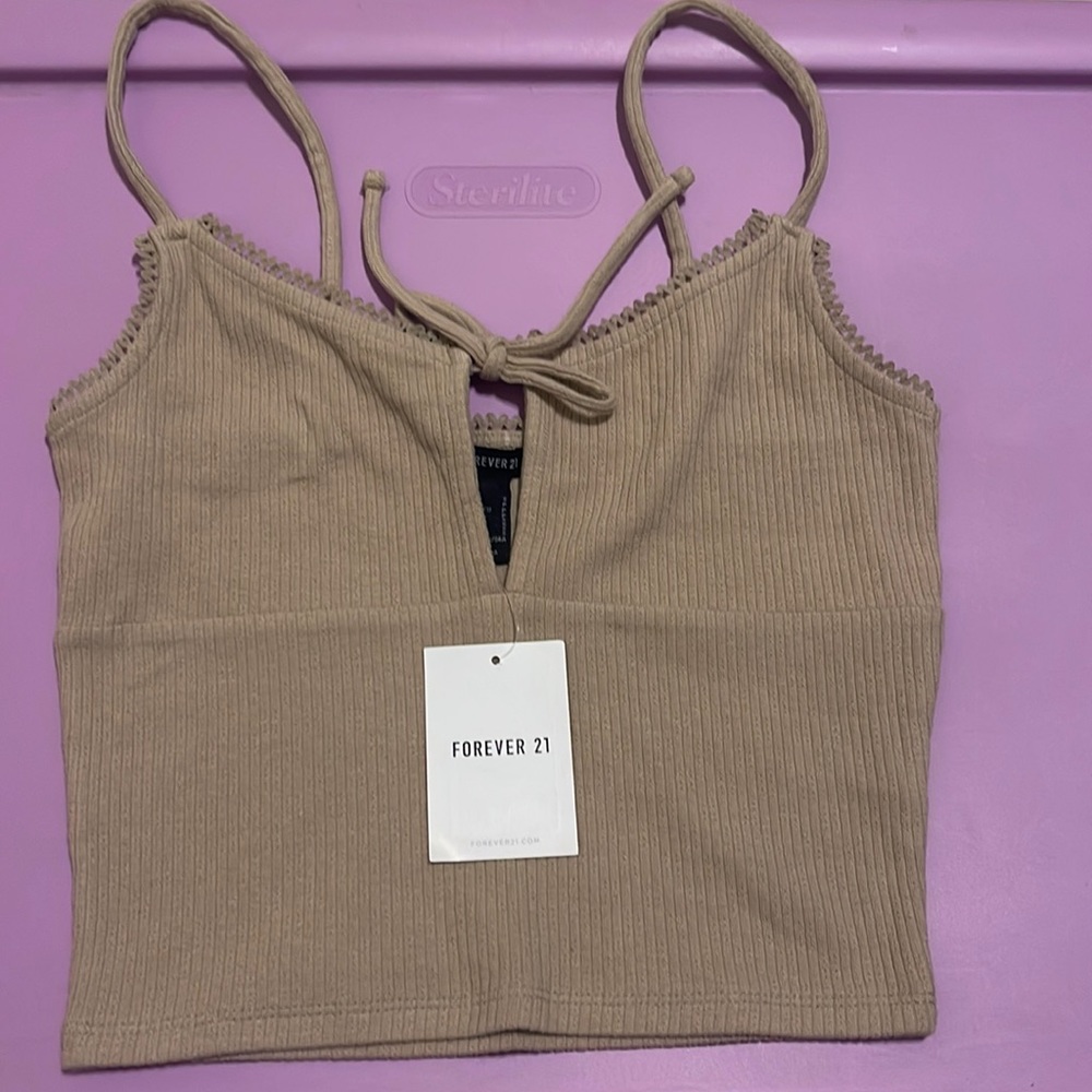 could be worn as a size XS brand new has never been worn beige kind of color